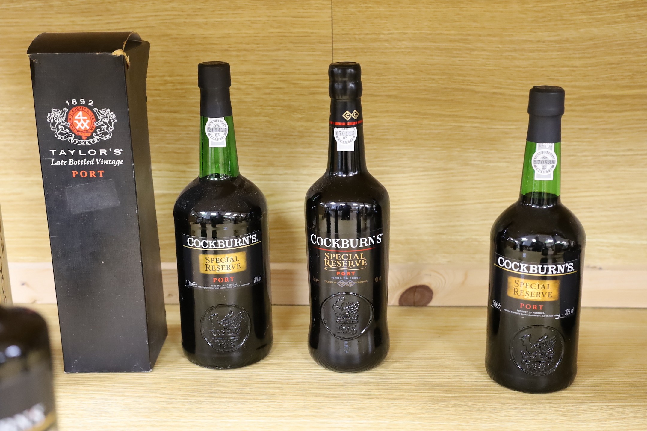 A cased 1996 bottle of vintage Cockburn’s port, together with seven other bottles of various port
